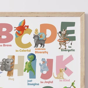 May include: A framed alphabet art print featuring colorful illustrations of animals and positive affirmations. The letters are in various colors, with phrases like "be Brave," "be Colorful," and "be Energetic" accompanying each letter.