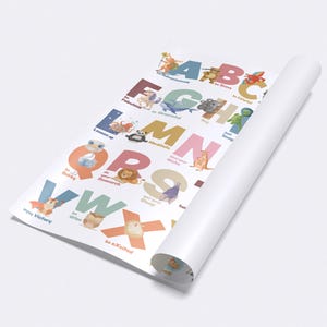 May include: Rolled-up educational poster featuring the alphabet with colorful letters and animal illustrations. The poster has a white background and is partially unrolled, revealing the letters A through X. The illustrations include a variety of animals.