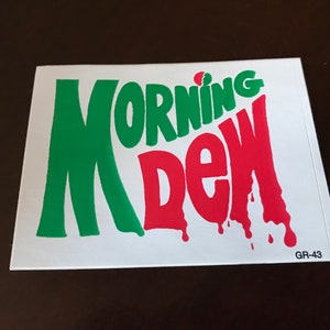 May include: A white sticker with the words "Morning Dew" in green and red lettering. The sticker has a red drip effect and the text "GR-43" in the bottom right corner.