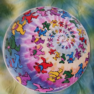 May include: A round sticker with a tie-dye background and a spiral pattern of dancing bears in various colors. The text "©1998 GDM, INC." is at the bottom of the sticker.