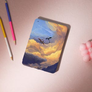 May include: A blue and yellow e-reader case featuring a painting of two dragons flying through the clouds.