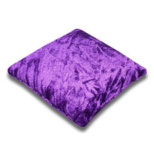 May include: A plush purple square pillow with a soft, velvety texture.