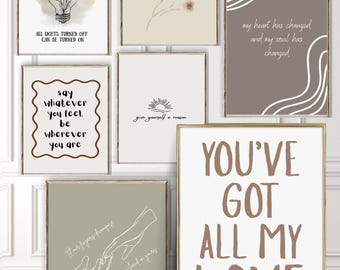 May include: A gallery wall set of seven framed art prints featuring various designs. Prints include line art of a lightbulb with flowers, a floral stem, abstract waves, a sun, two hands holding, and text quotes including YOU'VE GOT ALL MY LOVE.