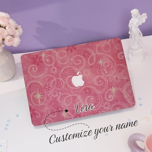 May include: Pink laptop cover with a floral and swirl design, featuring the Apple logo. The cover is personalised with the name "Lisa" and the text "Customize your name".