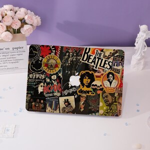 May include: A laptop case adorned with a collage of rock band logos and images. The case displays logos for The Beatles, AC/DC, and others, with a white Apple logo. The background is a mix of black, red, and white.