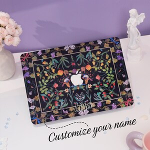May include: A black laptop case with a floral design and the name "Lisa" printed on it. The case has a customizable name feature.