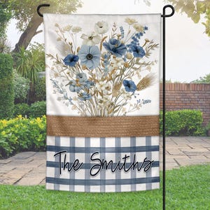 May include: A blue and white checkered garden flag with a burlap border and a bouquet of blue and white flowers. The text "The Smiths" is printed in black cursive on the flag.