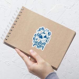 May include: A blue and white sticker with a globe and books around it. The text reads "And all the books in all the world could not contain all that Jesus said and did! John 21:25"
