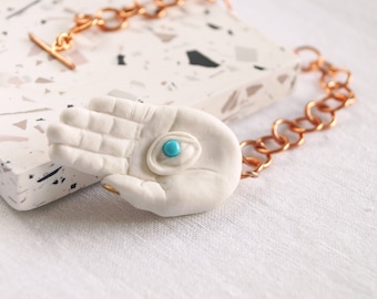 Mystic EYE LIGHT pendulum, sculpted porcelain hand, turquoise, copper, gold
