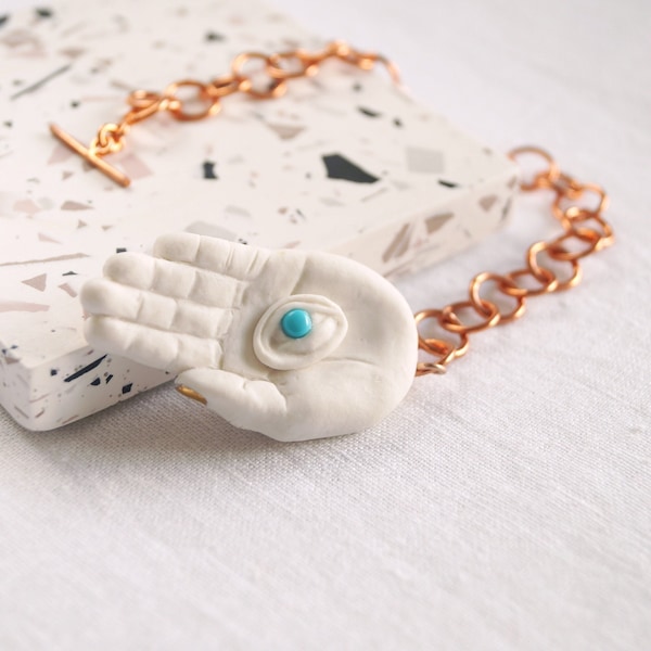 Mystic EYE LIGHT pendulum, sculpted porcelain hand, turquoise, copper, gold