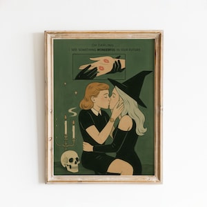 May include: Framed art print featuring two women kissing, one in a witch hat. The artwork has a green background with a skull, candles, and the text "OH DARLING... I SEE SOMETHING WONDERFUL IN YOUR FUTURE."