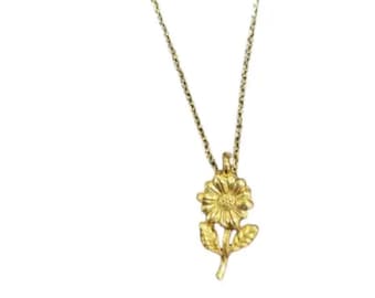 May include: A gold-colored necklace featuring a detailed sunflower pendant. The pendant is a three-dimensional design with petals, leaves, and a stem. The chain is delicate and complements the floral charm.