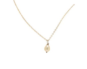 May include: A delicate gold chain necklace with a single, pear-shaped pearl pendant.