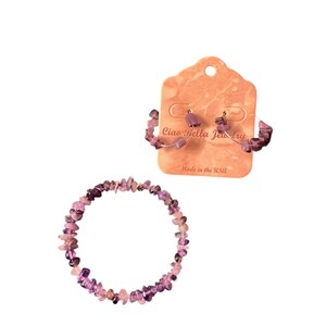 May include: A jewelry set featuring a bracelet and hoop earrings. The bracelet and earrings are made of small, irregularly shaped purple stones. The earrings are displayed on a peach-colored card that reads "Ciao Bella Jewelry" and "Made in the USA."