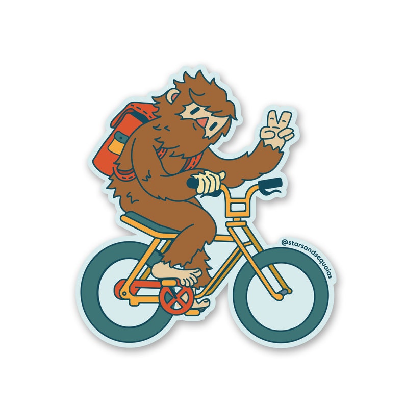 May include: A sticker featuring a cartoon Bigfoot riding a yellow bicycle with teal tires. The Bigfoot is brown with a red backpack and is giving a peace sign. The sticker has a light blue outline and the text "@starsandsequoias".