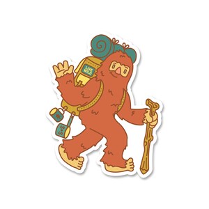 May include: A sticker featuring a cartoon Bigfoot character with orange fur, carrying a backpack and walking stick. The backpack has the words "LIVE WILD" on it. The Bigfoot is waving and has two mugs hanging from the backpack.