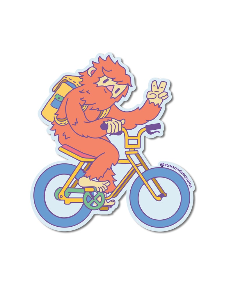 May include: A sticker featuring a cartoon Sasquatch riding a yellow bicycle with blue wheels. The orange-furred creature wears a yellow backpack and gives a peace sign. The sticker has a light blue border and the text "@starsandsequoias".