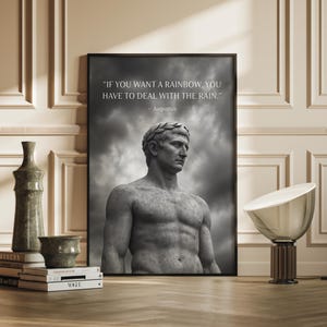 May include: Monochrome framed print of a statue of Augustus Caesar wearing a laurel wreath. The print displays the quote, "IF YOU WANT A RAINBOW, YOU HAVE TO DEAL WITH THE RAIN." by Augustus. Decorative items are in the foreground.
