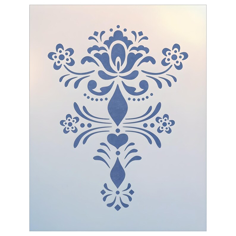 May include: A blue stencil featuring a symmetrical floral design. The design includes stylized flowers, hearts, and ornate scrollwork. The stencil is on a white background with a gradient effect, creating a soft, diffused look. Ideal for craft projects.