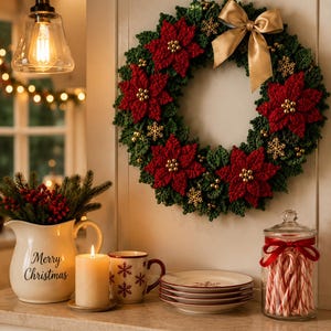 May include: A crochet Christmas wreath featuring dark green foliage, vibrant red poinsettia flowers, gold metallic snowflake ornaments, and a large gold satin ribbon bow. The wreath is displayed on a wall above a counter with holiday decor.