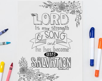 Peut inclure: Une page à colorier en noir et blanc avec le texte "The Lord is my strength & song and he has become my salvation" entouré de motifs floraux. Des crayons et des marqueurs de différentes couleurs sont éparpillés sur la page.