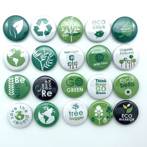 May include: A collection of 16 green and white round buttons with various eco-friendly messages and designs. The buttons feature phrases like "Go Green", "Eco Bella", "Tree Hugger", "Save the Planet", and "Eco Warrior".