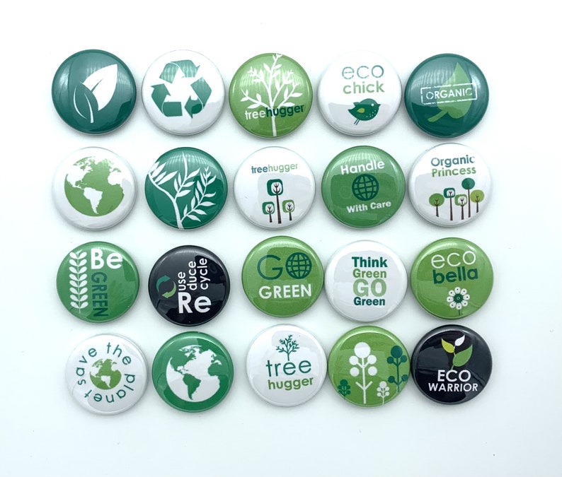 May include: A collection of 16 green and white round buttons with various eco-friendly messages and designs. The buttons feature phrases like "Go Green", "Eco Bella", "Tree Hugger", "Save the Planet", and "Eco Warrior".