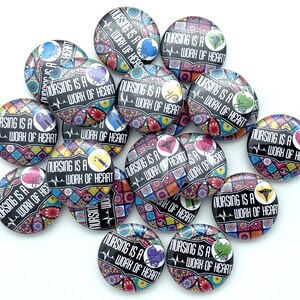 May include: A collection of colorful round buttons with the text "Nursing is a work of heart" and various medical symbols.