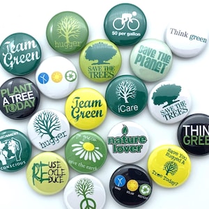May include: A collection of 18 round green, yellow, black, and white button pins with various environmental slogans and images. The slogans include "Team Green", "Save the Planet", "Plant a Tree Today", "Think Green", "Save the Trees", "Hugger", "iCare", "Go Green", "Nature Lover", "Use Recycle Reduce", "Have You Hugged a Tree Today?", "Wind Solar Recycle", and "$0 per gallon".