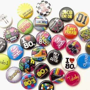 May include: A collection of 20 colorful 80s themed buttons with various designs and text, including "I love the 80s", "Totally Rad", "Gnarly", "Take a Chill Pill", "Save Ferris", "Break'n", "Dude", "867-5309", "Sk8 or Die", "Hey You Guys", "I Survived the 80s", "Stay Gold Ponyboy", "Wear My Sunglasses at Night", "I Miss the 80's", "Grody to the Max", "Totally", "I the 80s", "01", "Gnarly", "I the 80s".
