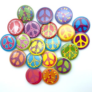 May include: A collection of 18 colorful peace sign buttons with various designs, including floral patterns, geometric shapes, and peace symbols. The buttons are arranged in a circle on a white background.