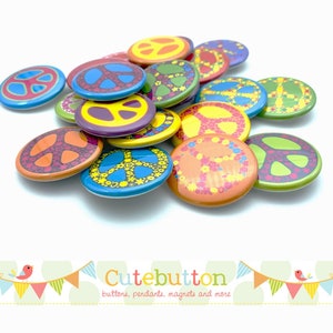 May include: A pile of colorful peace sign buttons with various floral and geometric designs. The buttons are all round and about 1 inch in diameter. The text "Cutebutton" is visible at the bottom of the image.