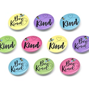 May include: Ten round, colorful buttons with a bee and the text "Bee Kind" or "Kind" on each. The buttons are in various colors, including yellow, green, pink, purple, and blue.
