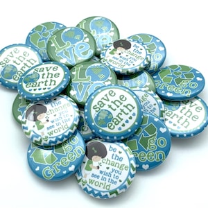 May include: A collection of colorful round buttons with various environmental messages, including "Save the Earth", "Go Green", and "Be the Change You Wish to See in the World".