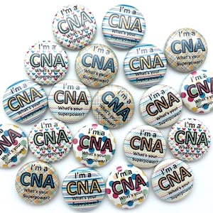 May include: A collection of 16 colorful round buttons with the text "I'm a CNA What's your Superpower?" printed on each button. The buttons have different patterns, including hearts, stripes, polka dots, and zigzags.