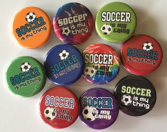 May include: Ten round buttons with a soccer ball graphic and the text "Soccer is my thing" in various colors, including orange, green, blue, red, purple, black, and tie-dye.