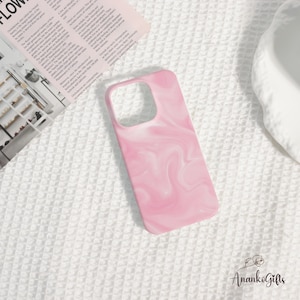 May include: A pink and white marbled phone case. The case has a rectangular shape with rounded corners and a cutout for the camera. The design features a swirling pattern of pink and white, creating a unique and stylish look. The case is made of a smooth, glossy material.