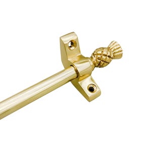 May include: A gold-colored curtain rod with a pineapple finial. The rod is attached to a rectangular bracket with two screw holes. The pineapple finial adds a decorative touch to the hardware.