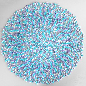 Pu&ograve; includere: Un centrino rotondo fatto a mano, con un motivo floreale. Il centrino &egrave; lavorato all'uncinetto con filato bianco, azzurro e viola. I bordi hanno un design smerlato. Questo articolo decorativo &egrave; adatto per l'arredamento della casa.