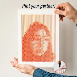 May include: A portrait of a person is created using orange and yellow lines on a white background. The artwork is held by a person wearing a blue shirt. The text "Plot your partner!" is at the top.