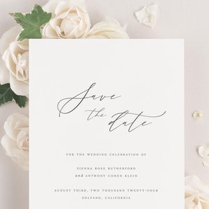 May include: Save the date card with white flowers. The card reads "Save the date" in cursive script. The text below reads "For the wedding celebration of Sienna Rose Rutherford and Anthony Cohen Klein. August third, two thousand twenty-four. Solvang, California. Formal invitation to follow."