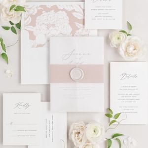 May include: Wedding invitation suite with a floral design. The invitation card is white with a pink floral pattern on the back. The RSVP card is white with the text "Kindly Reply by June First". The details card is white with the text "Details" and information about the wedding. The celebration card is white with the text "Celebrate" and information about the wedding.