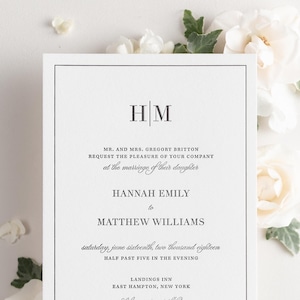 May include: A white wedding invitation with black text. The invitation announces the marriage of Hannah Emily to Matthew Williams on Saturday, June 16th, 2018 at 5:30 PM at the Landings Inn in East Hampton, New York. The invitation includes the couple's initials, "H|M", at the top.