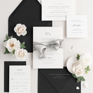 Gabriella invitation styled with fog ribbon and onyx envelopes.