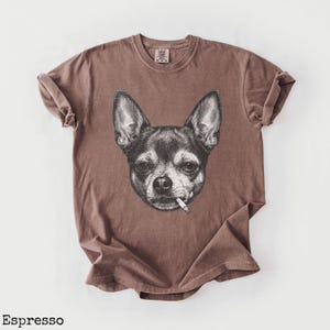May include: Espresso-coloured t-shirt with a black and white illustration of a Chihuahua smoking a cigarette. The shirt has a vintage appearance. The word "Espresso" is printed at the bottom of the image.