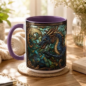 May include: A ceramic mug with a purple handle and interior, featuring a wrap-around design of a blue dragon set against a green and teal stained glass background with intricate gold filigree borders and decorative scrollwork elements.