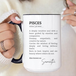 May include: A white ceramic mug with a black handle and interior rim. The front features black text defining Pisces as a deeply intuitive soul, followed by the custom name Samantha in a script font. The design includes the word Pisces in bold.