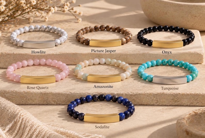 May include: Seven beaded bracelets with metal bars. The bracelets feature Howlite, Picture Jasper, Onyx, Rose Quartz, Amazonite, Turquoise, and Sodalite beads. Each bracelet has a smooth, curved metal bar in either a gold or silver tone.
