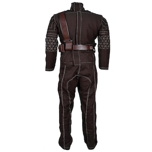 May include: A brown jumpsuit with white stitching and a brown leather belt and shoulder strap. The suit has diamond-patterned accents on the sleeves and a high collar. The pants have a straight leg design.