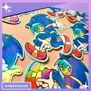 May include: A collection of die-cut stickers featuring an anime-style character with teal hair wearing a blue hooded jacket, blue pants, white gloves, and red sneakers with gold buckles. The stickers have a holographic finish and a dynamic pose.